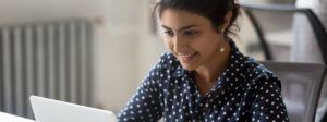 stockphoto of female smiling at laptop