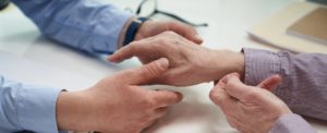 close up photo of patient and doctor hands