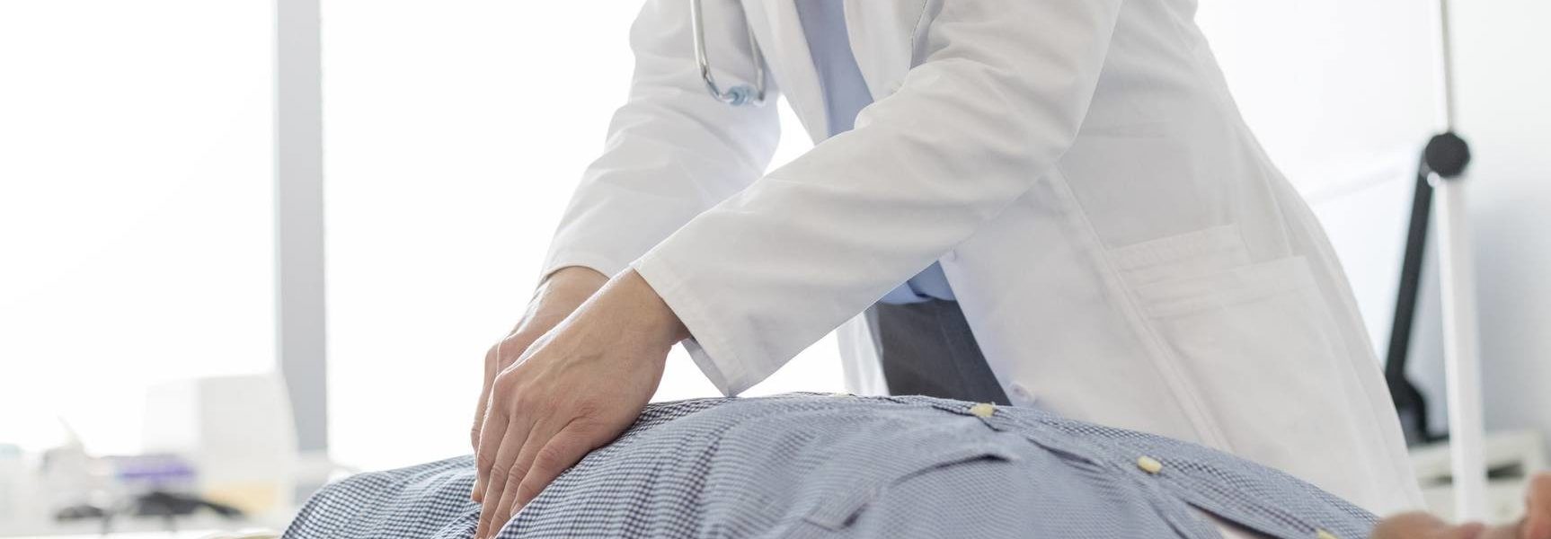 female doctor examining patient stomach