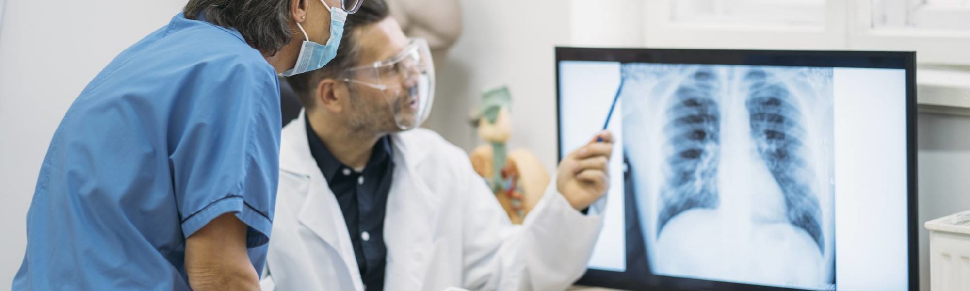 doctor and nurse looking at x-ray images