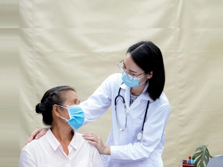 doctor supporting female patient