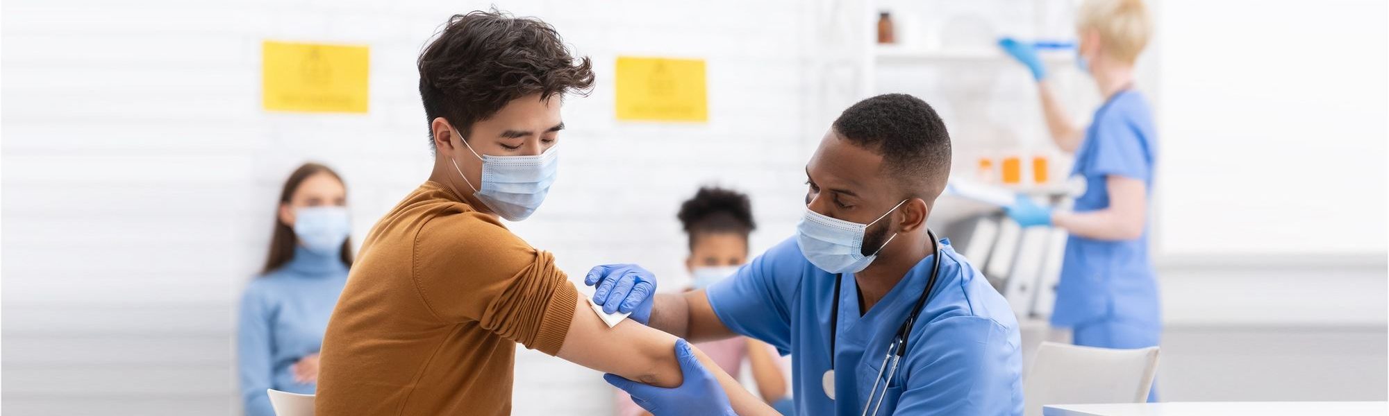 nurse prepping male patient for vaccination