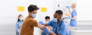 nurse prepping male patient for vaccination