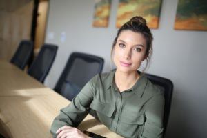 Woman at conference table.